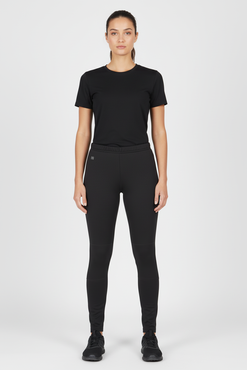 Dame i svarte smarte varmebukser med USB-temperaturkontroll for vinteraktiviteter